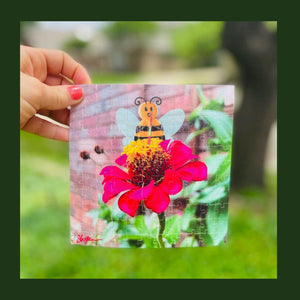 This mini puzzle is a digital composition of a cute honey bee character using a straw to drink from a pink flower. The puzzle in this photo is being held for a "puzzle pick up challenge"