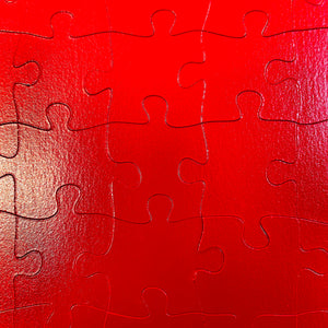 puzzle piece detail: 2-sided monochrome fire engine red puzzle
