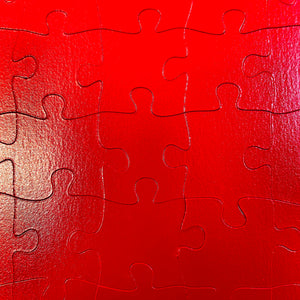 puzzle piece detail: 2-sided monochrome fire engine red puzzle